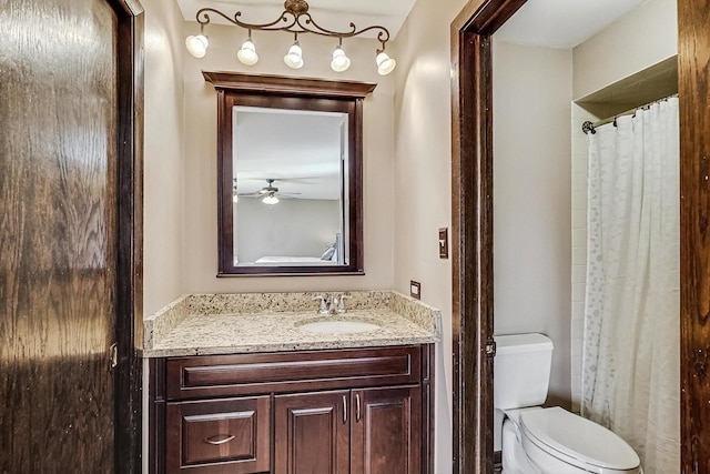 bathroom featuring toilet, curtained shower, and vanity