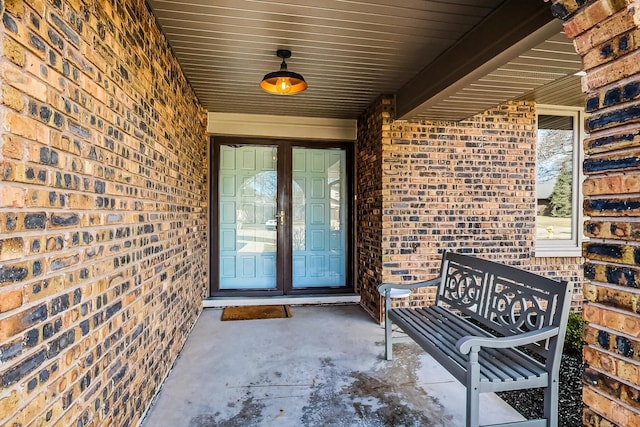 property entrance featuring brick siding