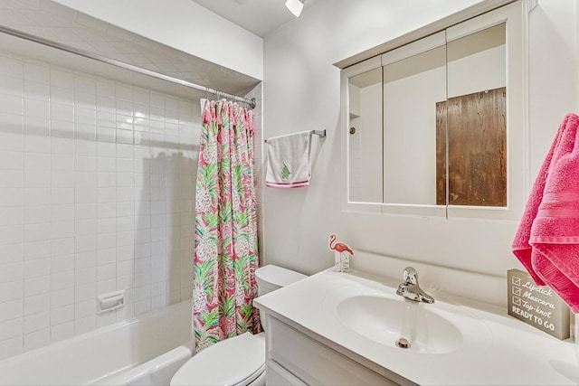 bathroom with shower / bath combination with curtain, toilet, and vanity