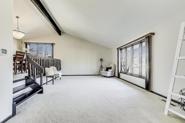 sitting room featuring carpet flooring, a healthy amount of sunlight, and vaulted ceiling with beams