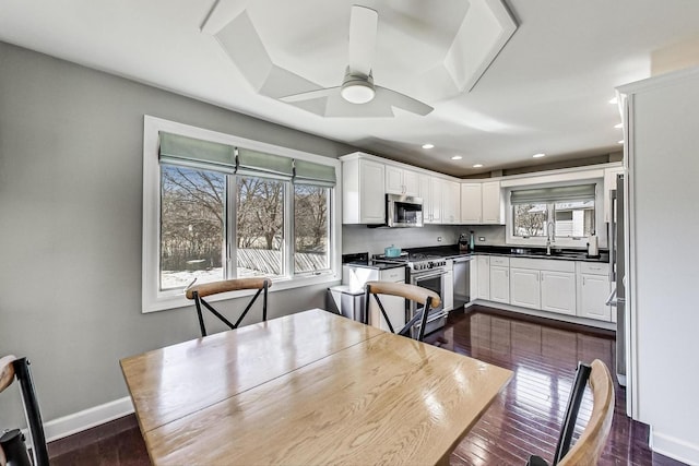 dining space featuring dark wood finished floors, recessed lighting, a ceiling fan, and baseboards