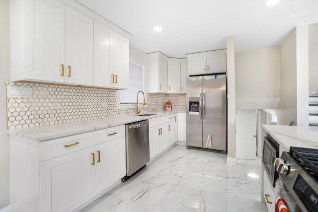 kitchen with light stone countertops, a sink, appliances with stainless steel finishes, marble finish floor, and backsplash