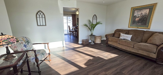 living room with wood finished floors and a ceiling fan