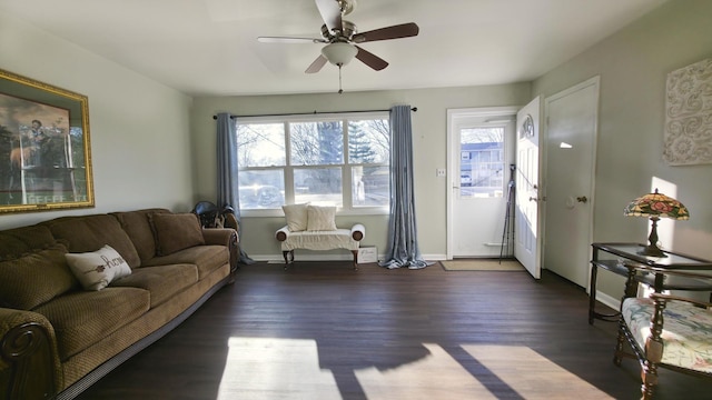 living room with a ceiling fan, wood finished floors, and baseboards