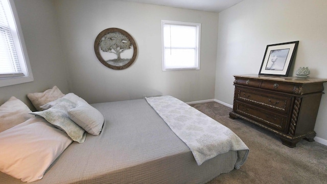 bedroom featuring baseboards and dark colored carpet