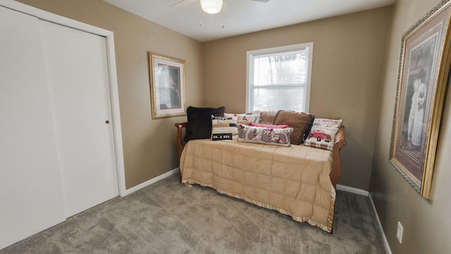 bedroom with a ceiling fan, baseboards, and carpet floors