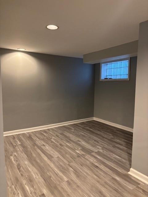 empty room with wood finished floors and baseboards