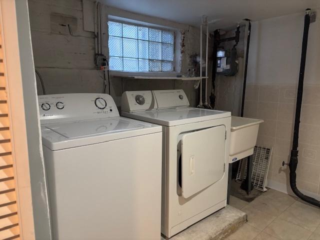 washroom featuring laundry area and separate washer and dryer