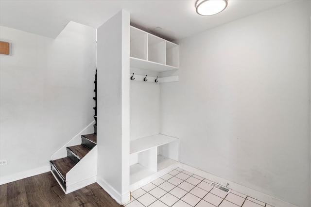 mudroom with visible vents, baseboards, and wood finished floors