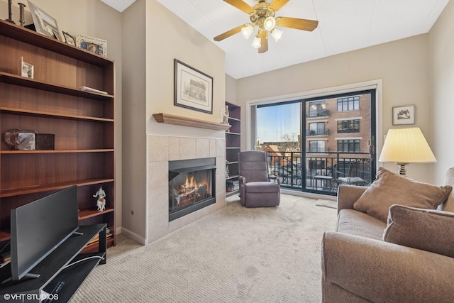 living room featuring a fireplace, vaulted ceiling, carpet, and ceiling fan