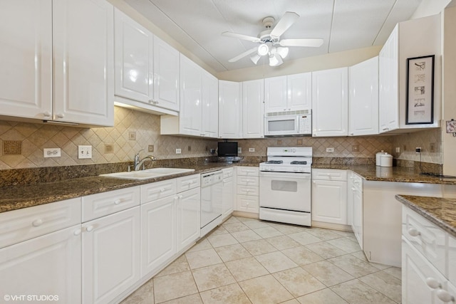 kitchen with decorative backsplash, white appliances, white cabinetry, and a sink