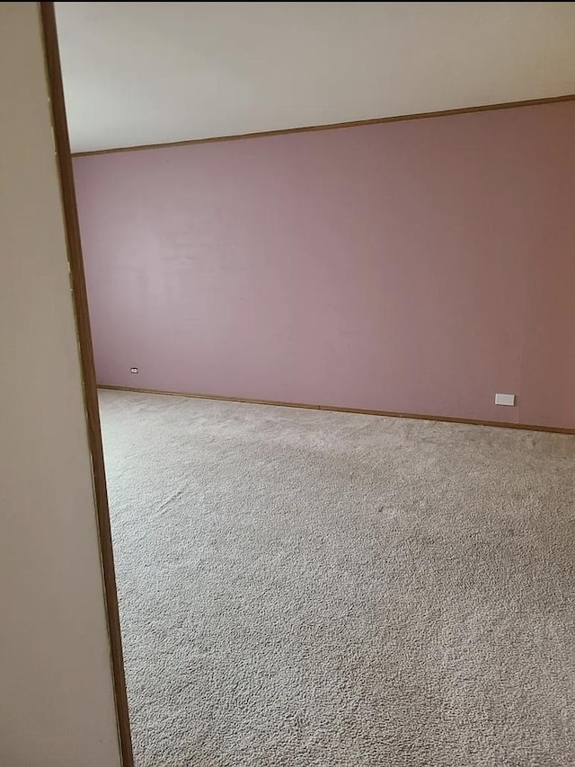 carpeted spare room with baseboards