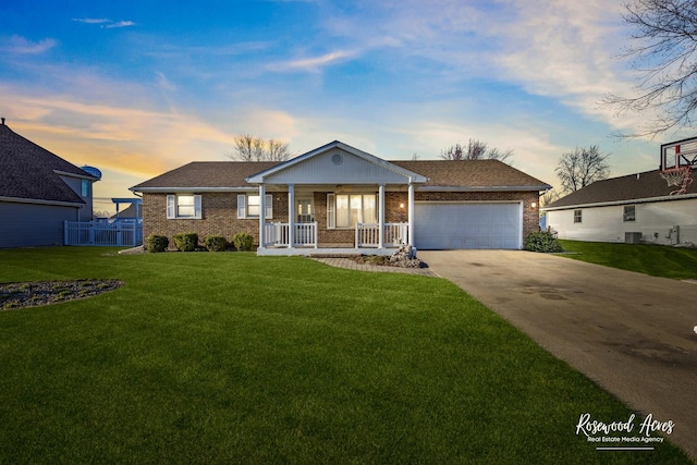 495 Water Tower Rd S, Manteno, IL 60950 - single story home with driveway, covered porch, an attached garage, brick siding, and a lawn