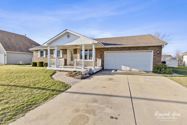 495 Water Tower Rd S, Manteno, IL 60950 - view of front of property with an attached garage, a front yard, brick siding, driveway, and covered porch
