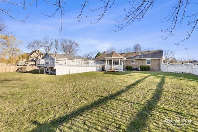 495 Water Tower Rd S, Manteno, IL 60950 - rear view of house with a lawn, a fenced backyard, a gazebo, and a deck