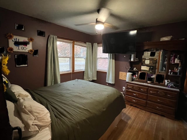 bedroom featuring a ceiling fan and wood finished floors