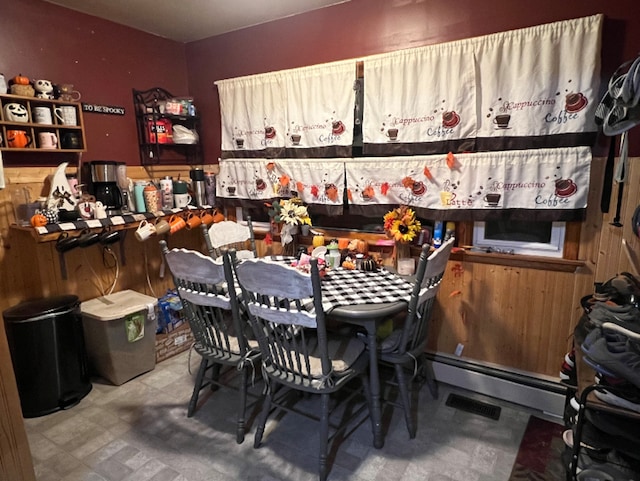 dining area featuring tile patterned floors and a baseboard heating unit