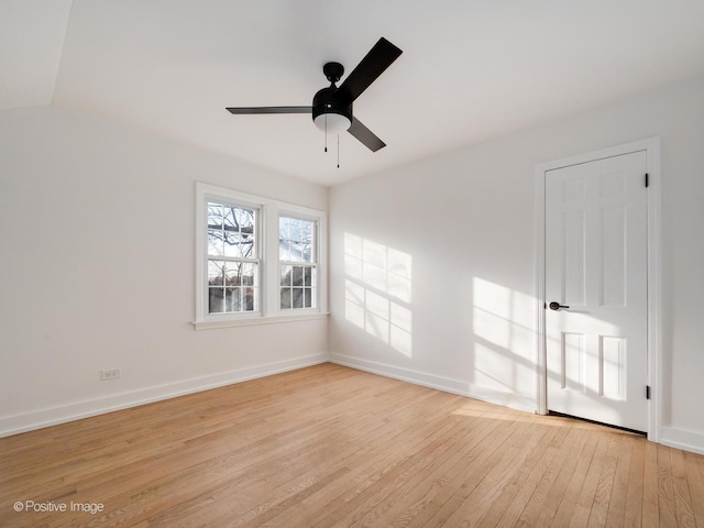 spare room featuring light wood-style flooring, baseboards, and ceiling fan