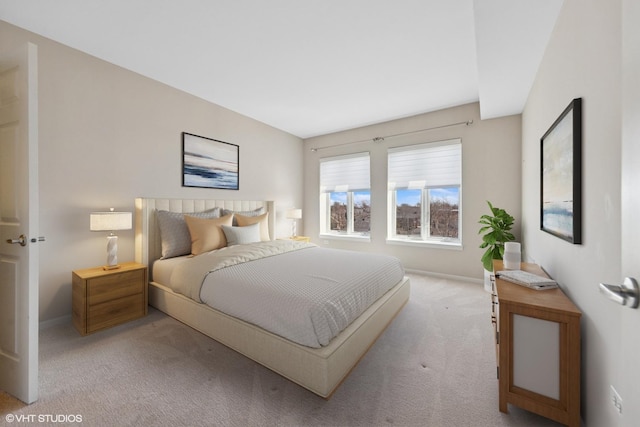 bedroom with baseboards and carpet