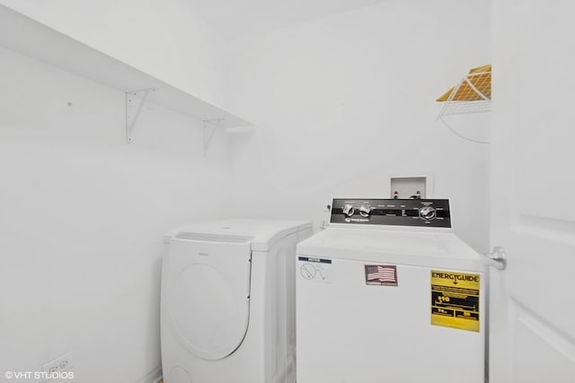 washroom featuring separate washer and dryer and laundry area