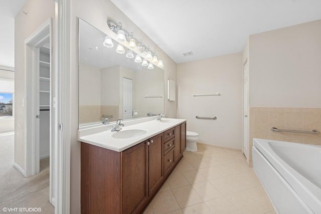 full bathroom with visible vents, a sink, tile patterned flooring, double vanity, and a bath