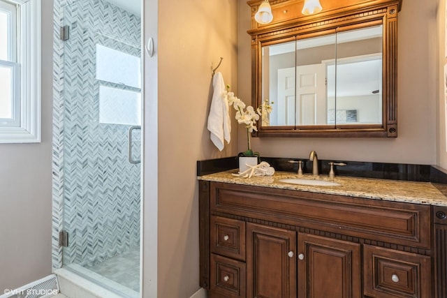 full bath with vanity and a shower stall