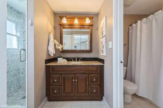 bathroom featuring curtained shower, baseboards, toilet, tile patterned floors, and vanity