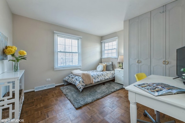 bedroom featuring visible vents and baseboards