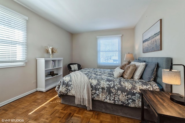 bedroom with multiple windows and baseboards