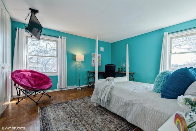 bedroom with multiple windows and baseboards