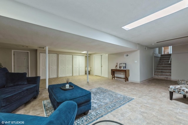 living room with stairs, baseboards, and visible vents