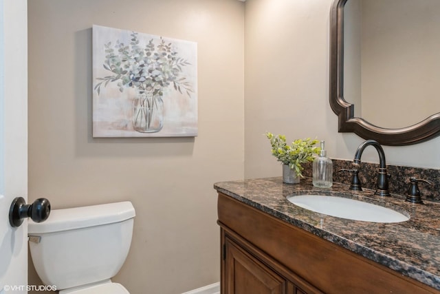 half bath featuring toilet and vanity