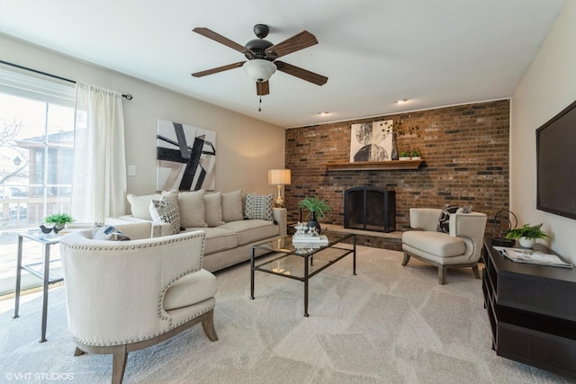 living room with carpet, a ceiling fan, and a fireplace