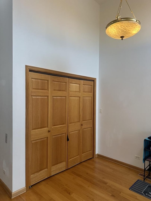 interior space featuring light wood-style floors and baseboards