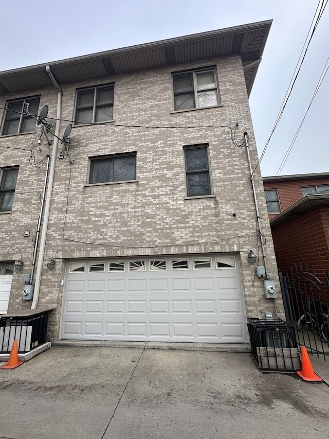 view of property featuring an attached garage and driveway