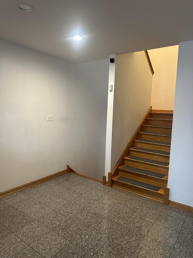 stairway with recessed lighting, baseboards, and granite finish floor