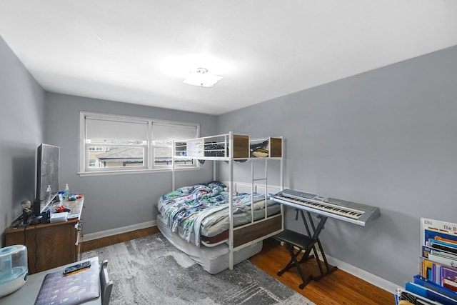 bedroom featuring baseboards and wood finished floors