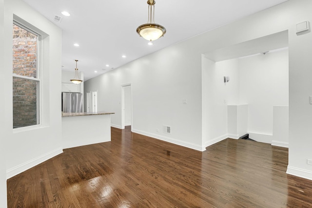 unfurnished living room featuring dark wood finished floors, recessed lighting, visible vents, and baseboards