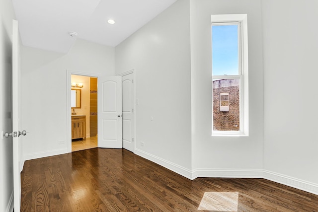 spare room with dark wood finished floors, recessed lighting, and baseboards