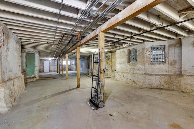 unfinished basement featuring electric panel