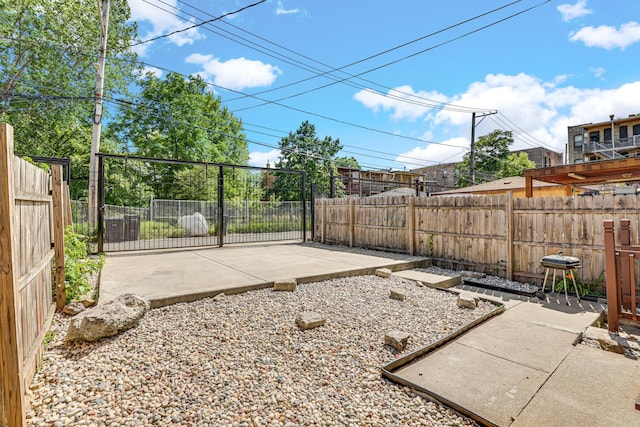 view of yard featuring a patio area and a fenced backyard