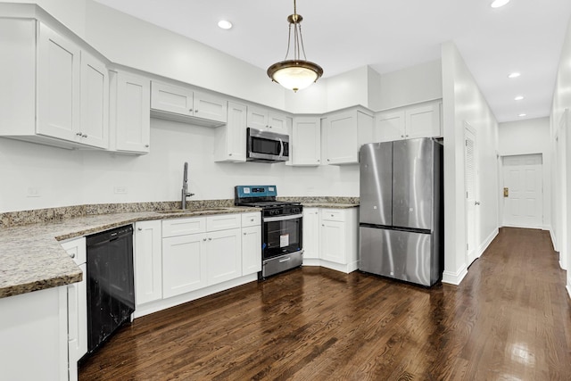 kitchen with a sink, recessed lighting, appliances with stainless steel finishes, light stone countertops, and dark wood-style flooring