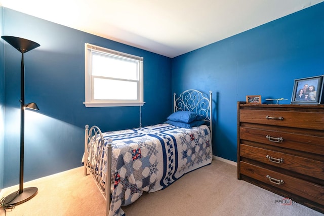 bedroom with baseboards and carpet