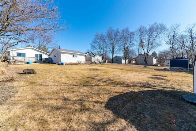 view of yard featuring fence and a wooden deck