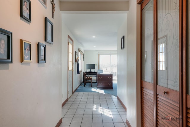 corridor with light tile patterned floors, recessed lighting, and baseboards