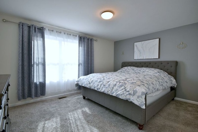 bedroom featuring carpet flooring and baseboards