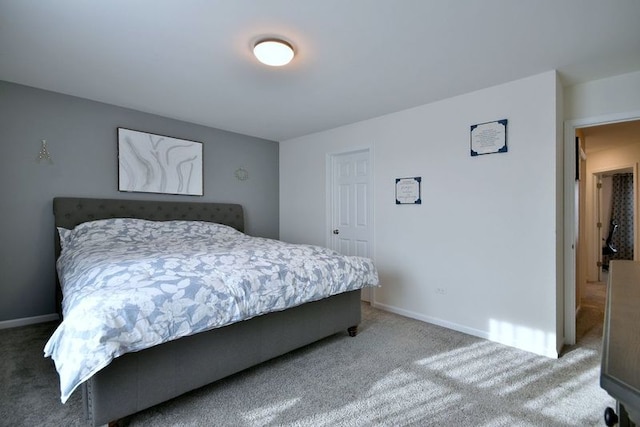 bedroom featuring baseboards and carpet