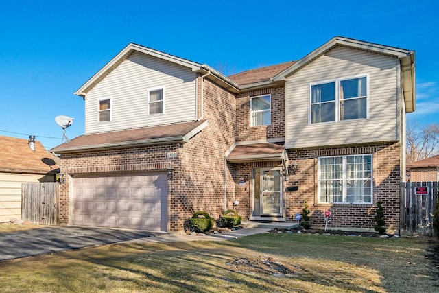 traditional-style home featuring aphalt driveway, fence, a front yard, an attached garage, and brick siding