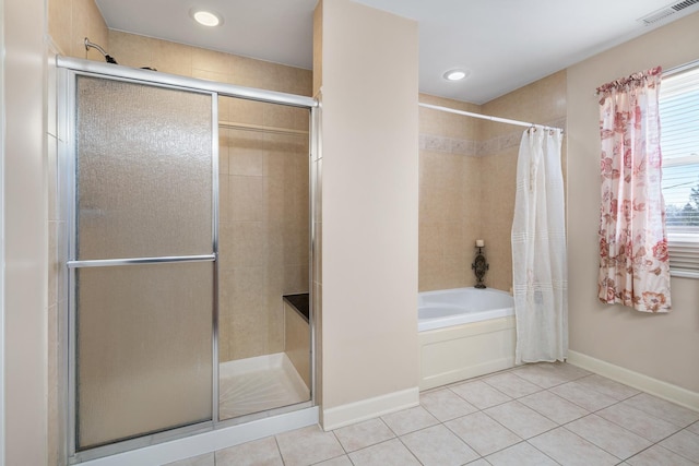 bathroom with visible vents, baseboards, tile patterned flooring, and a tile shower