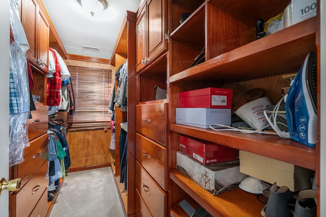 walk in closet with light colored carpet and visible vents